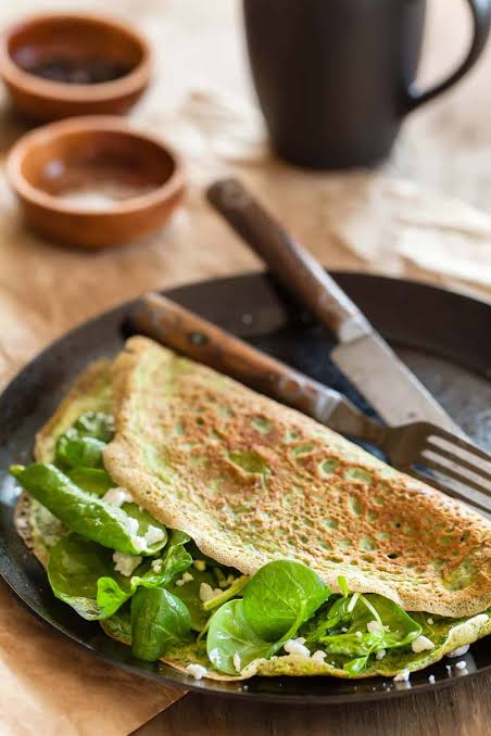 A folded spinach omelette on a plate