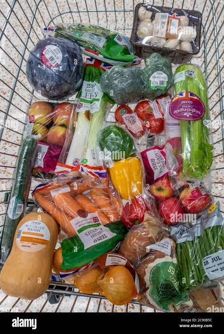 Shopping trolley filled with fresh fruit and vegetables