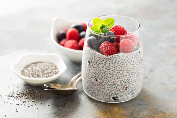 Chia pudding topped with raspberries, blueberries and mint