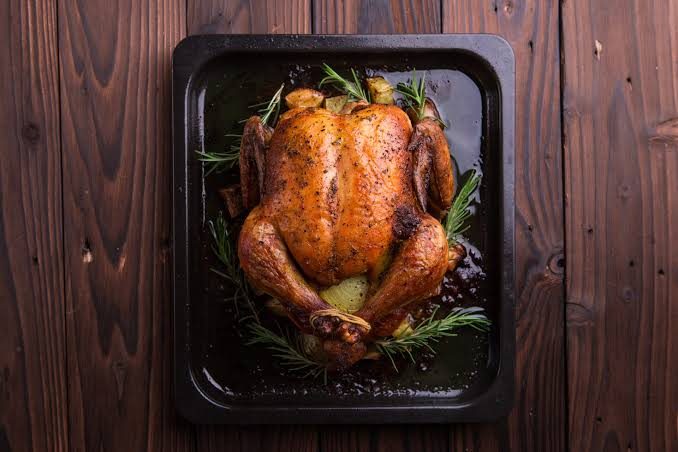 Roast chicken seasoned with fresh rosemary