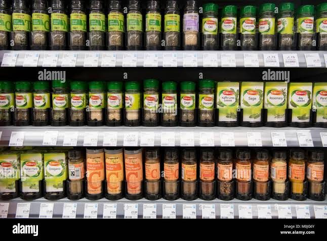 Shelves stocked with herbs and spices in a supermarket